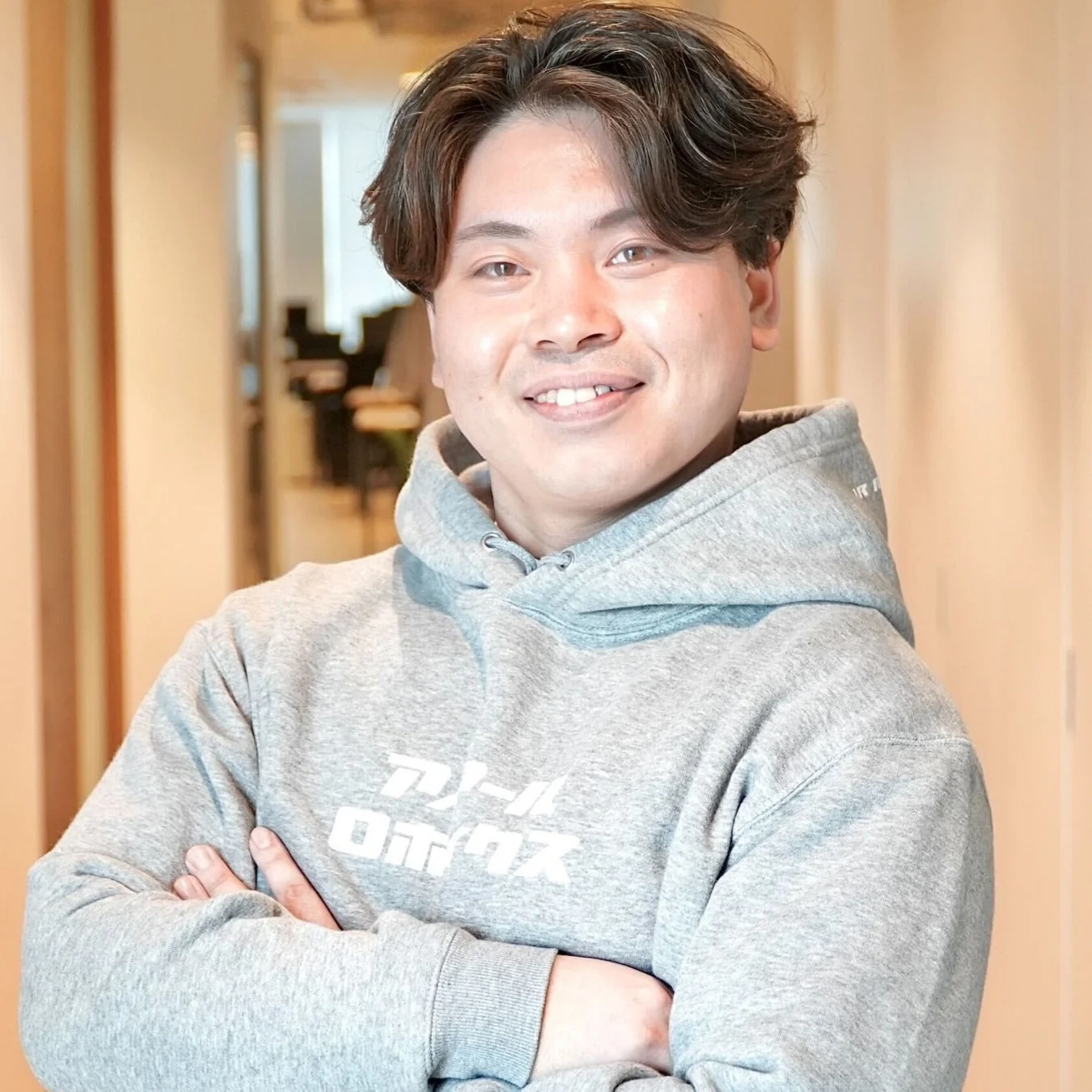 パーカー姿で笑顔の男性